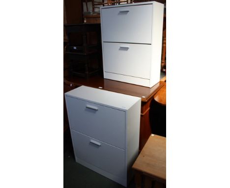 A pair of white shoe storage cupboards