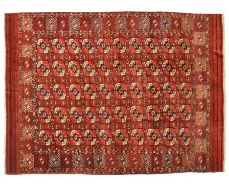 Tekke Turkmen Main Carpet Emirate of Bukhara, circa 1890 The madder field with five columns of quartered guls enclosed by bor