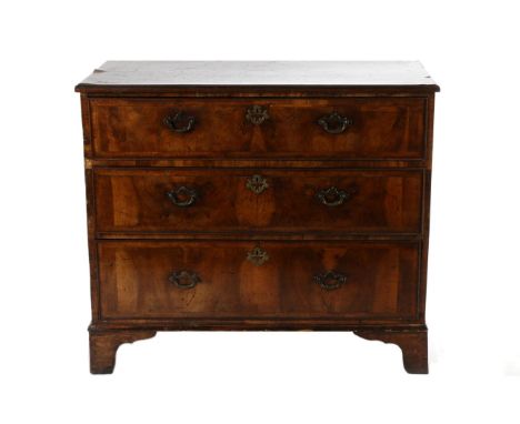 A George II Walnut and Oyster Veneered Three Drawer Straight Front Chest of Drawers, early 18th century, with a feather bande