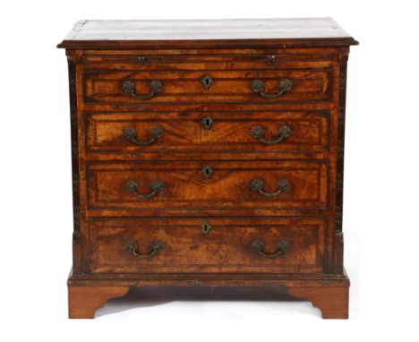 A George II Walnut, Crossbanded and Featherbanded Dressing Chest, 2nd Quarter 18th century, the moulded top above a pull-out 