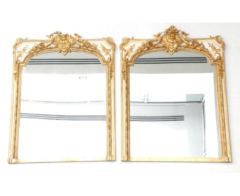 A Pair of French 19th Century Gilt and Gesso Console Mirrors, with later mirror plates contained with a beaded and moulded fr