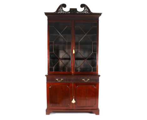 A George III Style Mahogany Bookcase, 3rd quarter 19th century, the fret carved swan neck pediment above a Greek Key pattern 