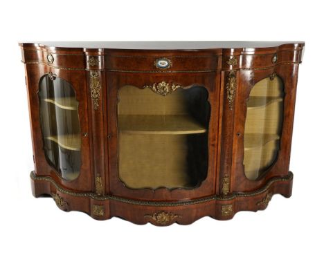 A Victorian Figured Walnut and Gilt Metal Mounted Credenza, circa 1870, of serpentine shaped form, the frieze with a blue ova