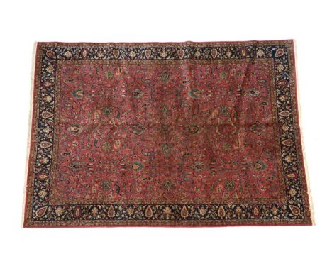 Lahore Carpet Punjab, India, circa 1920 The coral pink field with an all over design of palmettes and floral vines enclosed b