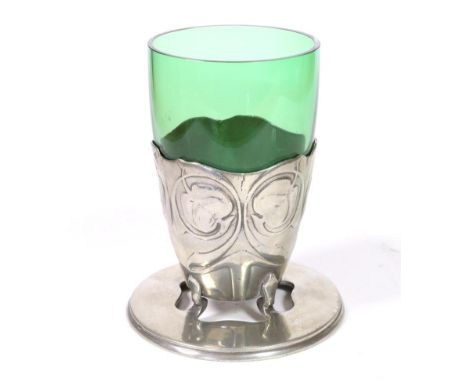 Archibald Knox (1864-1933) for Liberty & Co: A Tudric Pewter Vase, with green glass liner, cast with repeating foliage, on a 