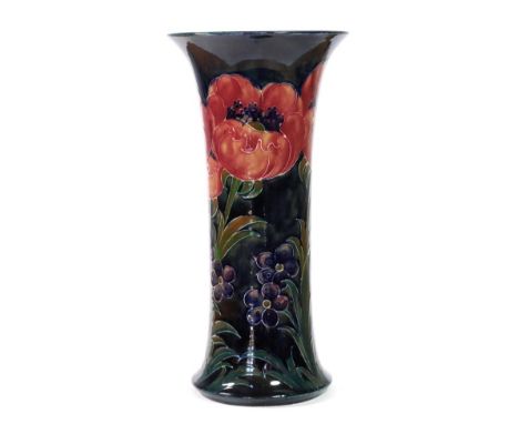 William Moorcroft (1872-1945): A Big Poppy Pattern Trumpet Vase, circa 1925, on a dark blue ground, impressed MOORCROFT BURSL