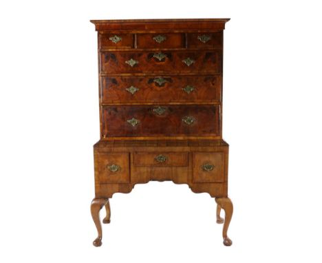 A George II Style Walnut and Featherbanded Chest on Stand, the moulded cornice above three short and three long graduated dra