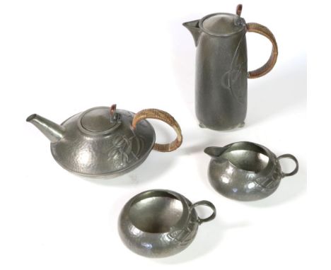 Archibald Knox (1864-1933) for Liberty & Co: A Tudric Pewter Four Piece Tea Service, comprising teapot with wicker covered ha