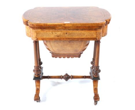 A Victorian Burr Walnut and Marquetry Inlaid Work/Games Table, circa 1870, the hinged lid enclosing a games and backgammon bo