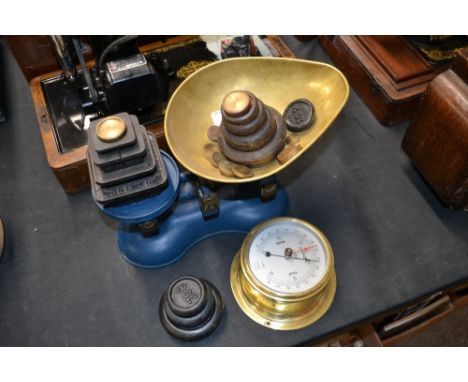 A brass cased barometer; together with a set of kitchen scales and weights 