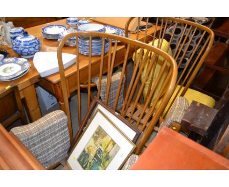A pair of Ercol armchairs (lacking cushions)
