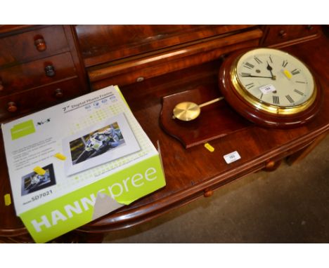 A modern quartz wall clock and a digital photo frame