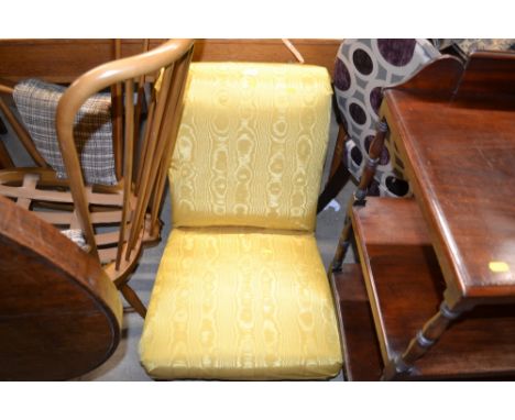 An Edwardian mahogany and yellow upholstered nursing chair 