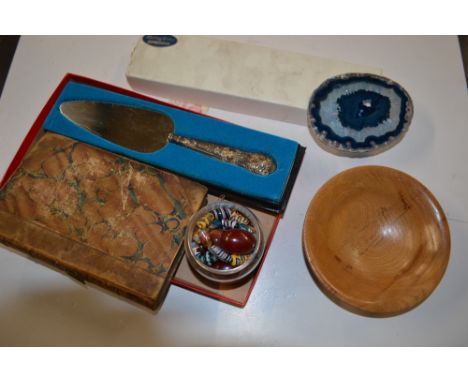 A sterling silver handled cake slice together with a brass button polisher;a tub of various beads; an edition of 'The History