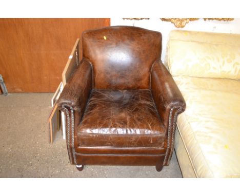 A brown leather and stud work arm chair 