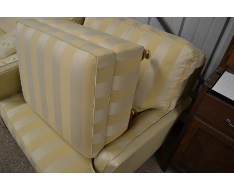 A Multiyork stripe upholstered arm chair and matching foot stool