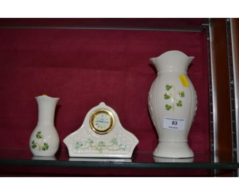A Belleek mantel clock and two Belleek vases 