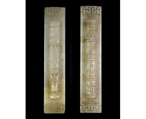 A pair of early 20th century Chinese white soapstone scroll weights, L. 15cm.