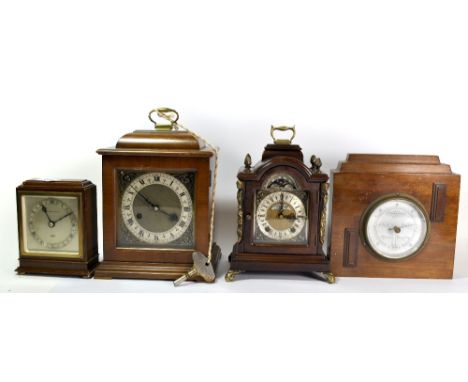 Three mahogany clocks and a barometer.