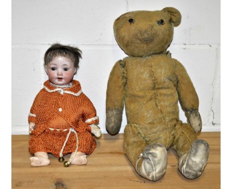 A porcelain headed German doll with composition body and a vintage teddy bear.  Doll h34cm