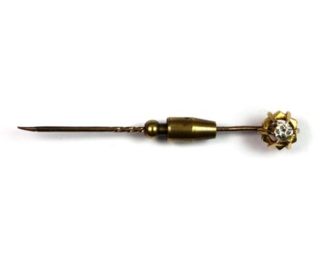 A yellow metal (tested 15ct gold) stick pin set with a solitaire diamond (0.25ct approx).