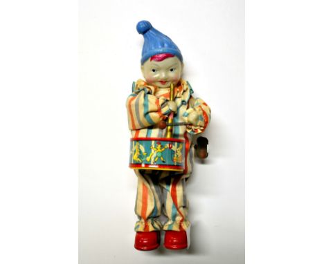 A vintage mechanical tin and celluloid drummer boy toy. H22cm