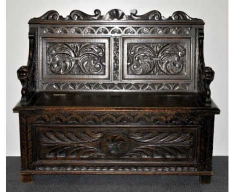 A 19thC carved oak monks bench. W122xh100cm