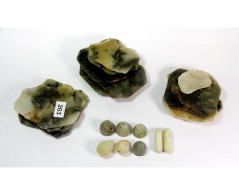 A collection of 19th century Chinese carved jade lily pads and seed pods.