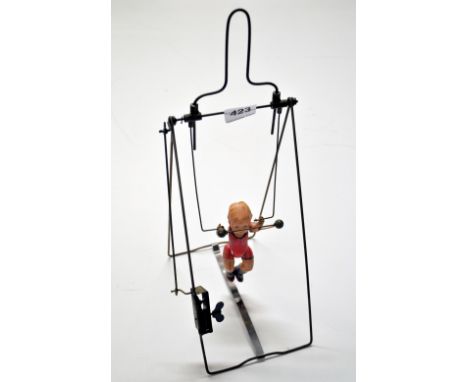 A vintage  mechanical tin and celluloid acrobat toy