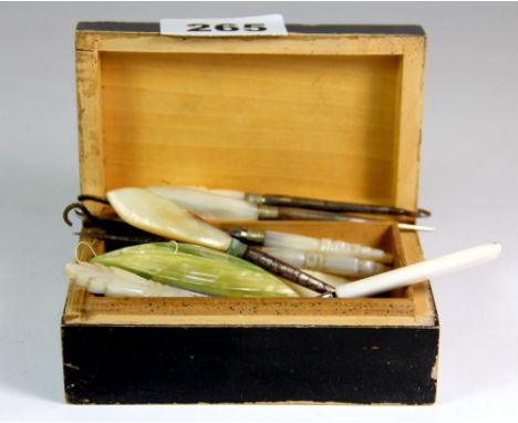 A collection of mother of pearl button hooks and bone thread holders, etc.