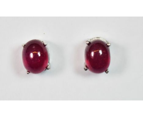 A pair of 925 silver and treated cabochon ruby earrings.