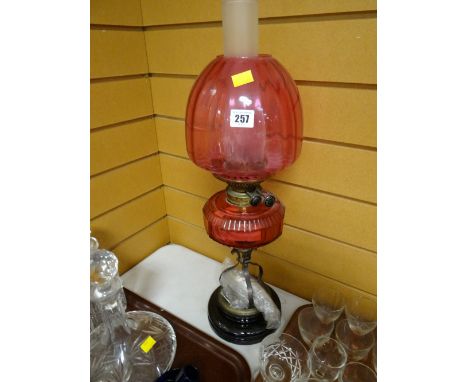 A nice cranberry glass shade & reservoir oil lamp