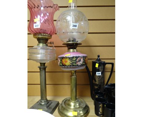 A brass Corinthian column based floral painted reservoir & clear glass shade oil lamp
