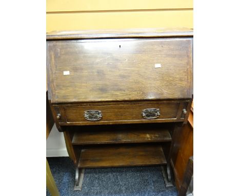 A vintage narrow oak bureau with bookshelf base