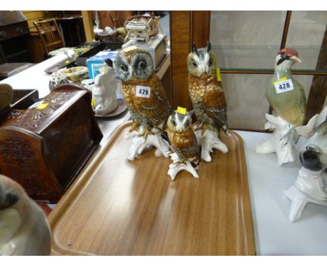 Three continental owl figures