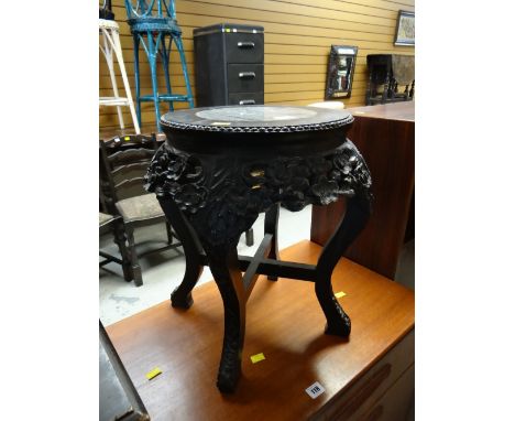 A carved ebonized wood & marble topped planter stand