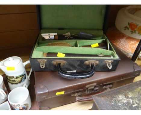 A vintage cased clarinet together with a small travel case