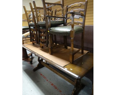 A good dark oak refectory-style dining table together with a set of six matching ladder back and green leather upholstered ch