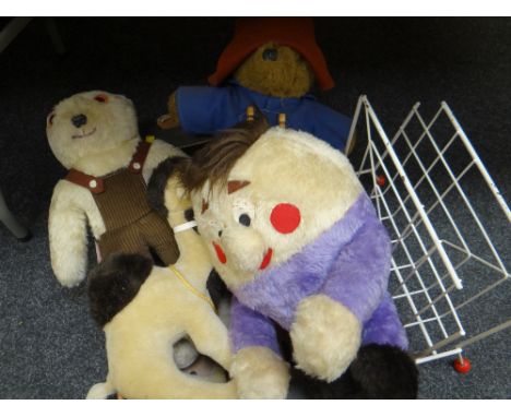 Various soft toys including Paddington Bear etc together with a vintage wire magazine rack