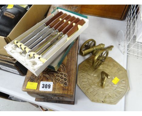 Carved topped wooden wine box, boxed knives, brass sundial & cannon