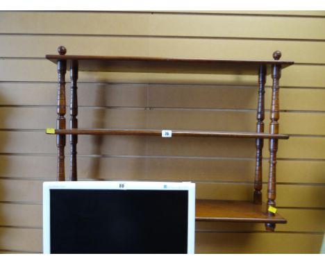 A mahogany three-tier hanging wall shelf