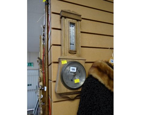 A light oak barometer/ thermometer