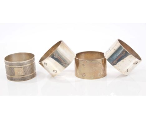 Set of three contemporary silver napkin rings of plain oval form (London 1971), maker - S. J. R., together with a 1930s silve