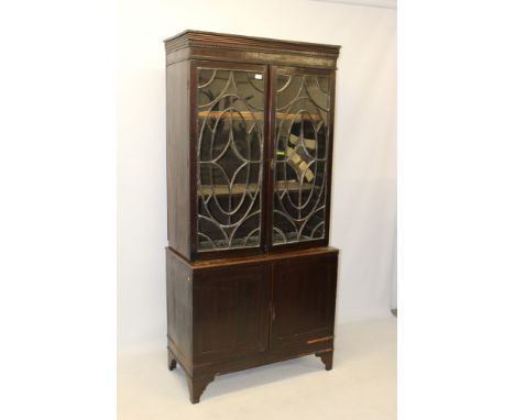 George III and later mahogany bookcase, the upper section with dentil cornice and enclosed by fine pair of astragal glazed do