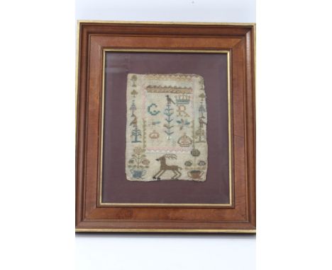 George III small needlework sampler dated 1778, with Royal cypher and animal and floral motifs, 19cm x 14cm in glazed frame