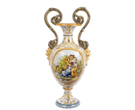 19th century Italian Majolica vase with double-scroll snake handles and demon mask mounts, polychrome painted with putti, cla