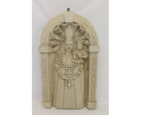 Carved stone niche of arched form, with Holy mother and child group, in architectural border, 90cm high