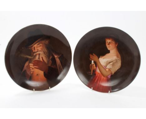 Pair late 19th century Vienna porcelain dishes painted with a girl in red dress, shielding a candle - the light illuminating 