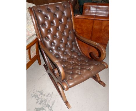 A Chesterfield style rocking chair with brown hide button back