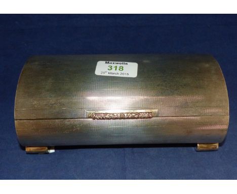 A rectangular engine turned arch top cigarette box with yellow metal handle and 4 oval feet, Birmingham 1950